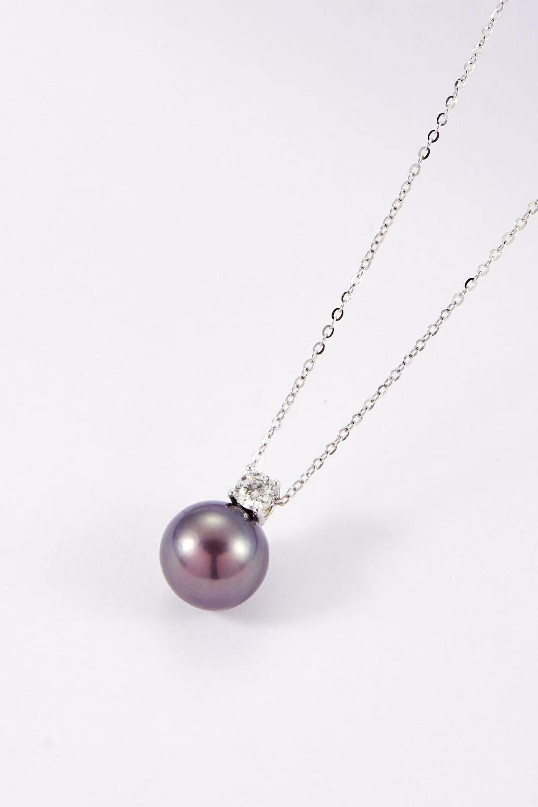 Purple iridescent pearl pendant with single CZ accent close-up