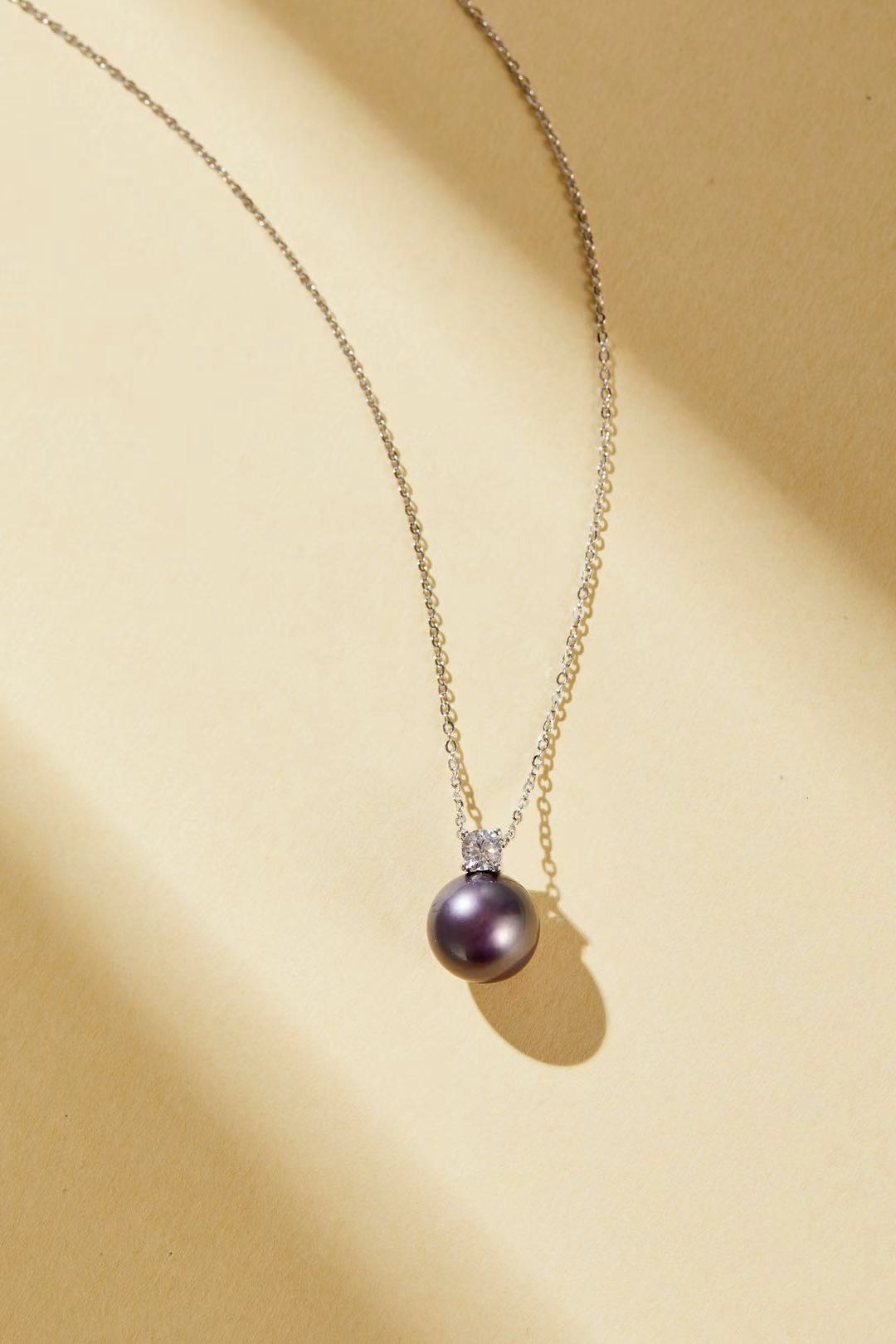 Purple iridescent pearl pendant with single CZ accent close-up