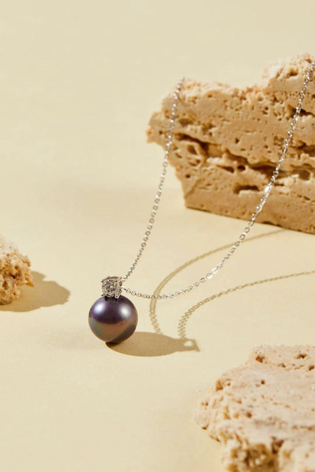 Purple iridescent pearl pendant with single CZ accent close-up