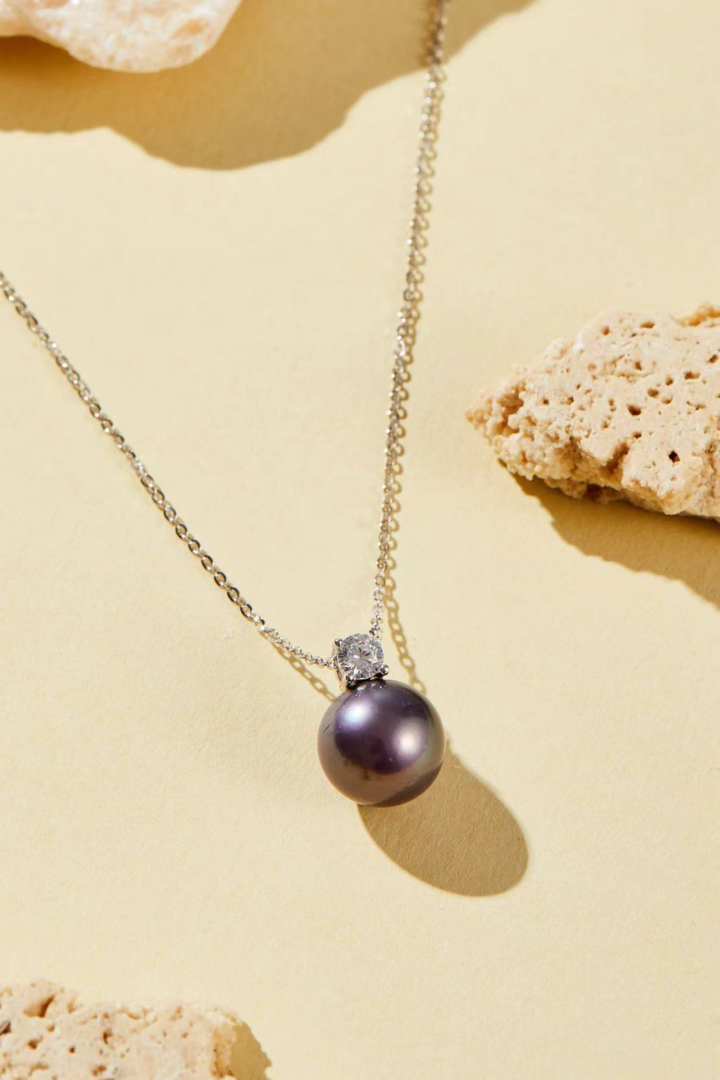 Purple iridescent pearl pendant with single CZ accent close-up