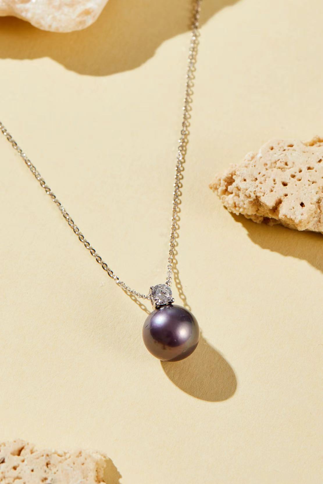 Purple iridescent pearl pendant with single CZ accent close-up