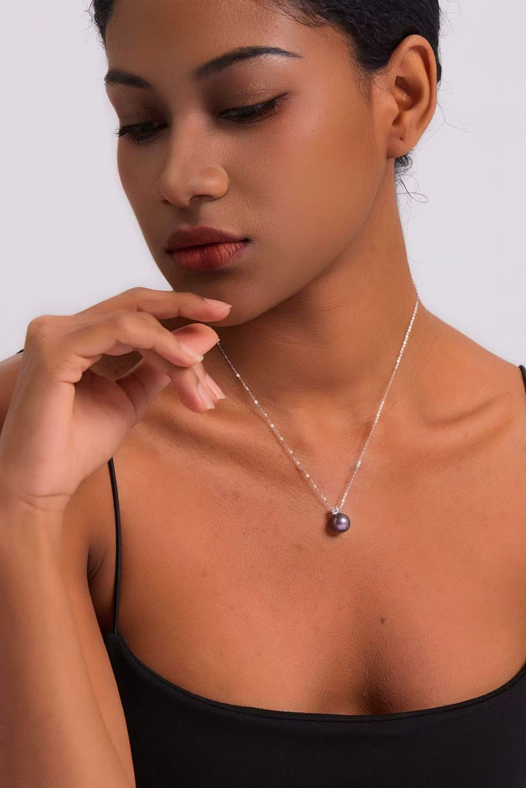 Model wearing Ethereal Amethyst pearl necklace at collarbone
