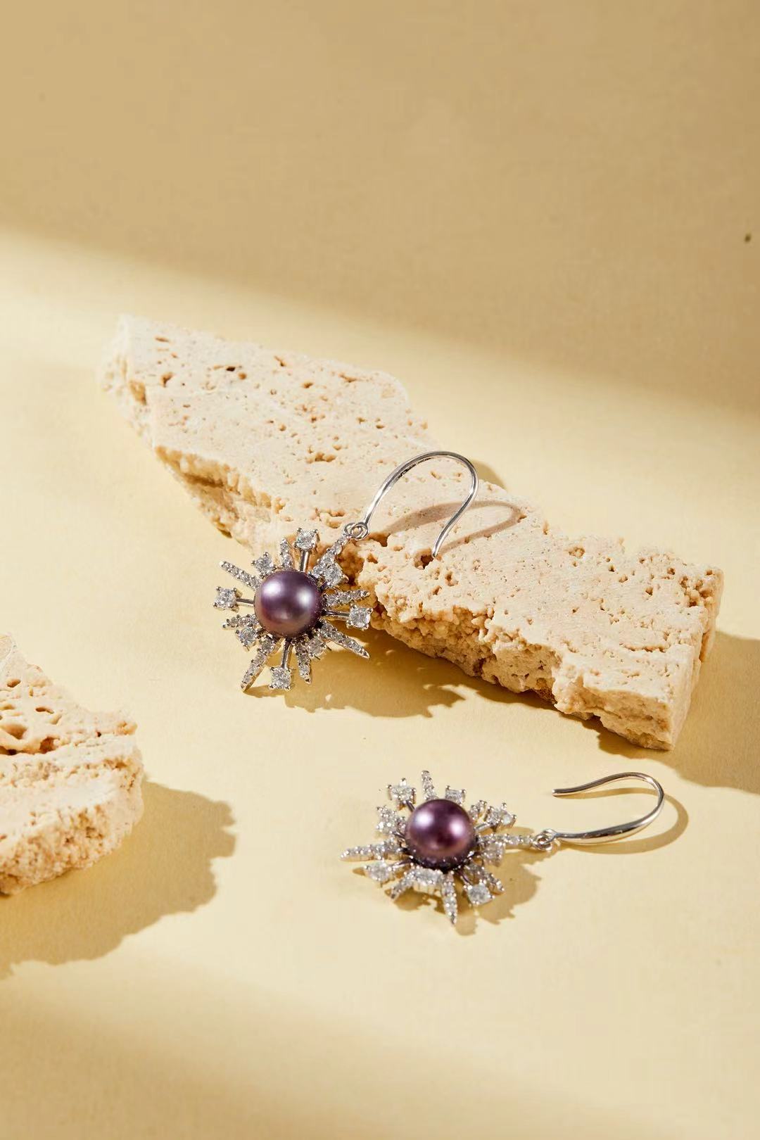 Close-up of purple iridescent fashion pearl with sparkling cubic zirconia accents