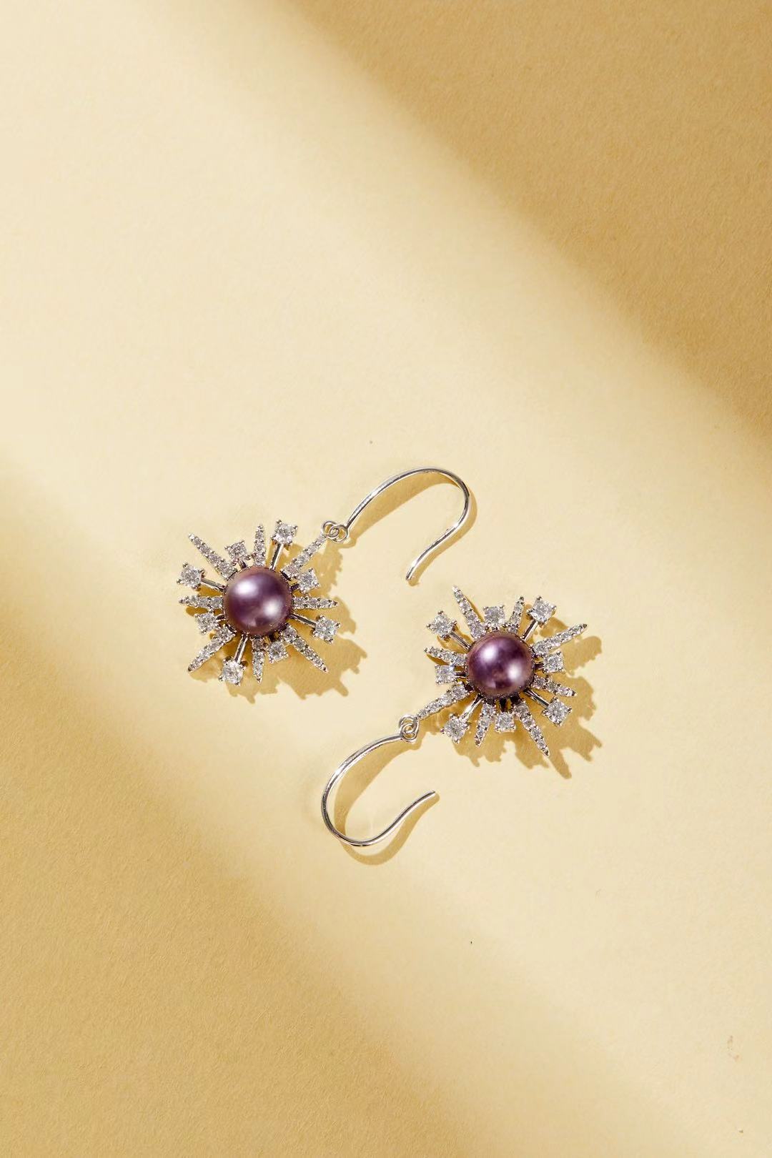 Close-up of purple iridescent fashion pearl with sparkling cubic zirconia accents