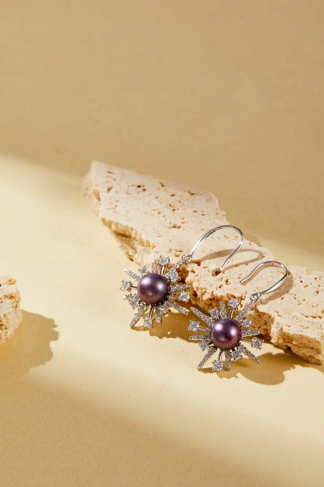 Close-up of purple iridescent fashion pearl with sparkling cubic zirconia accents