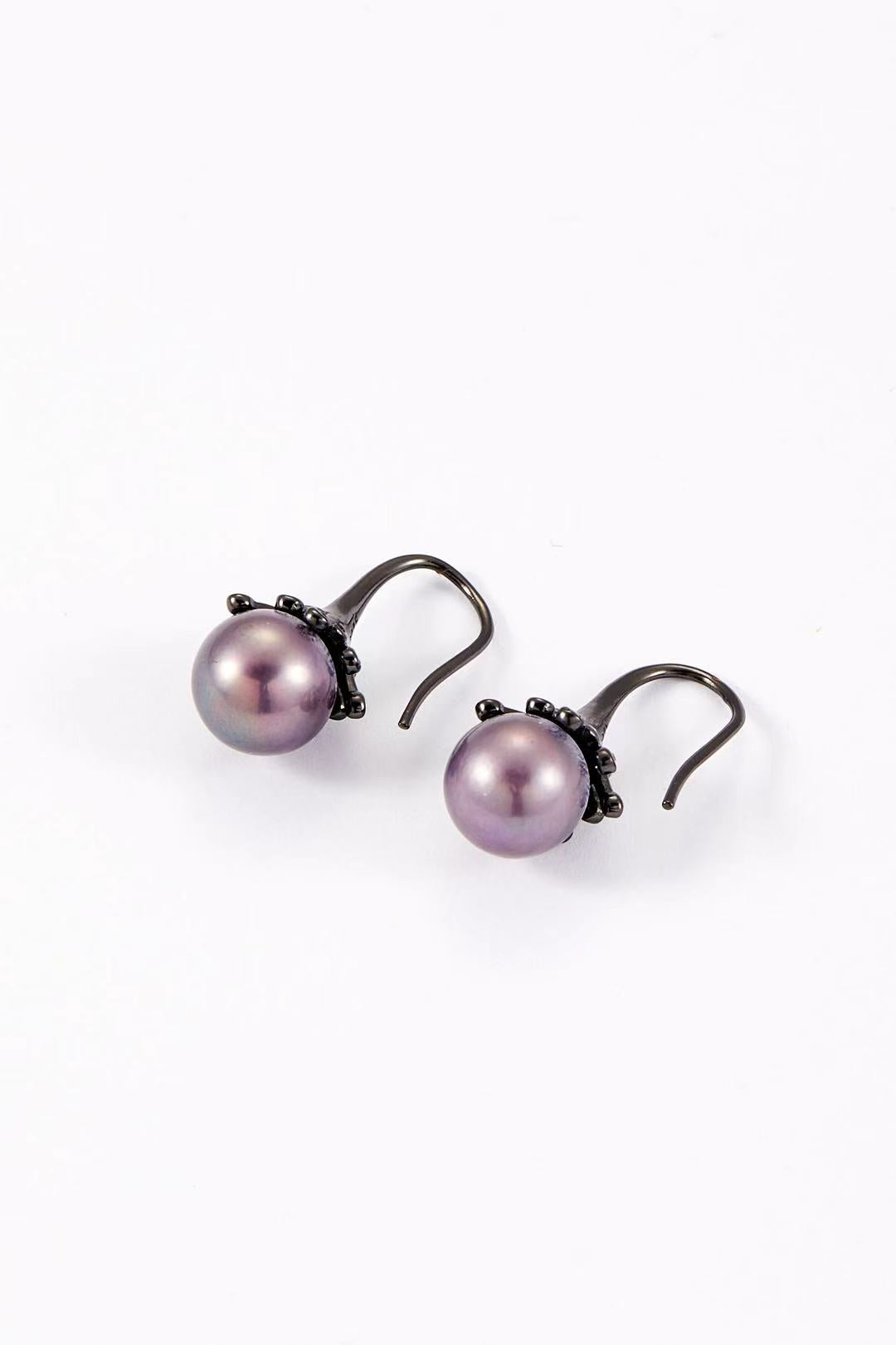 Purple iridescent pearl with dark alloy bud design close-up