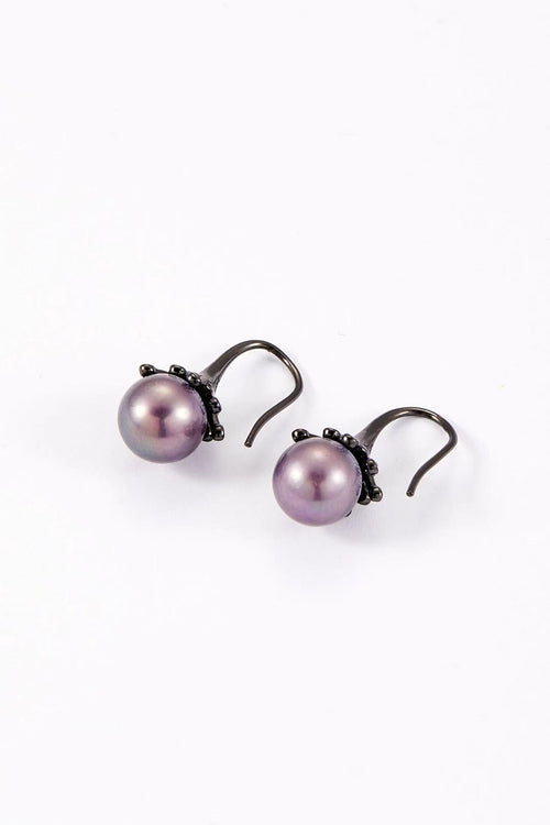 Purple iridescent pearl with dark alloy bud design close-up