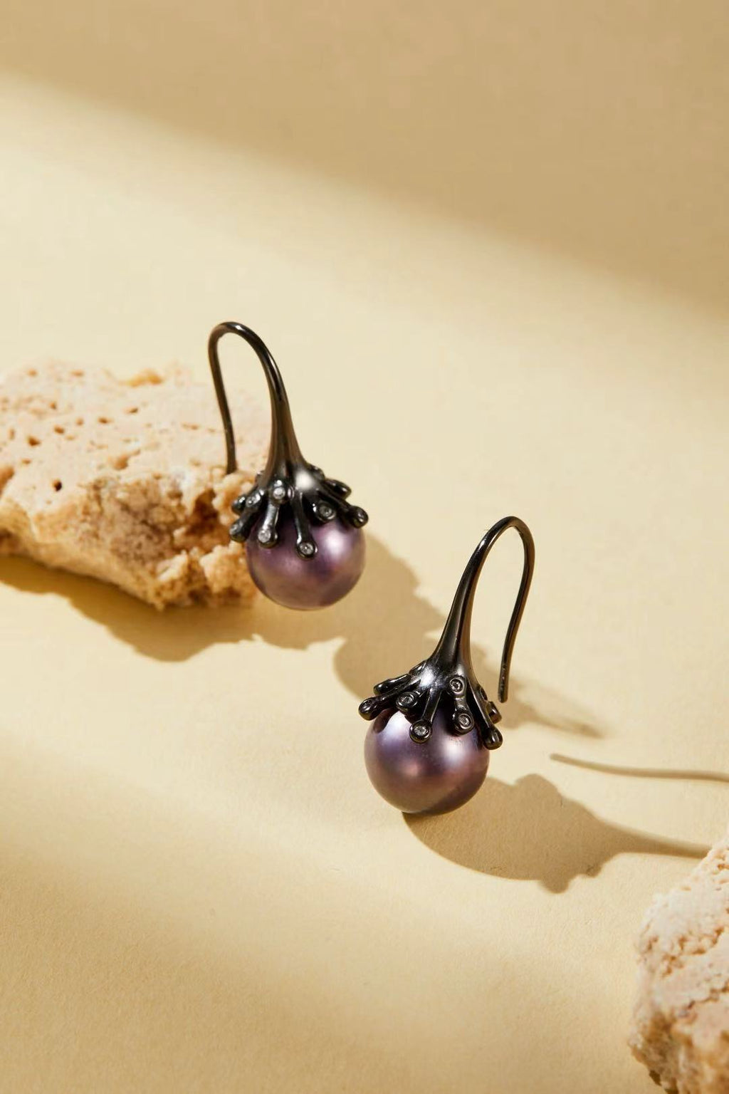 Purple iridescent pearl with dark alloy bud design close-up