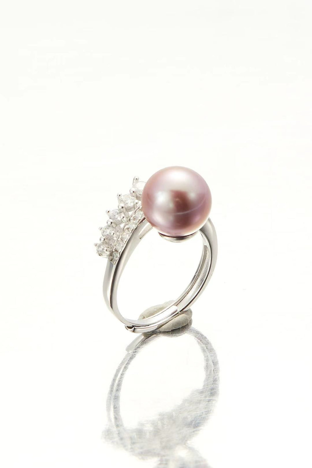 Lavender-pink iridescent pearl with sparkling CZ halo close-up