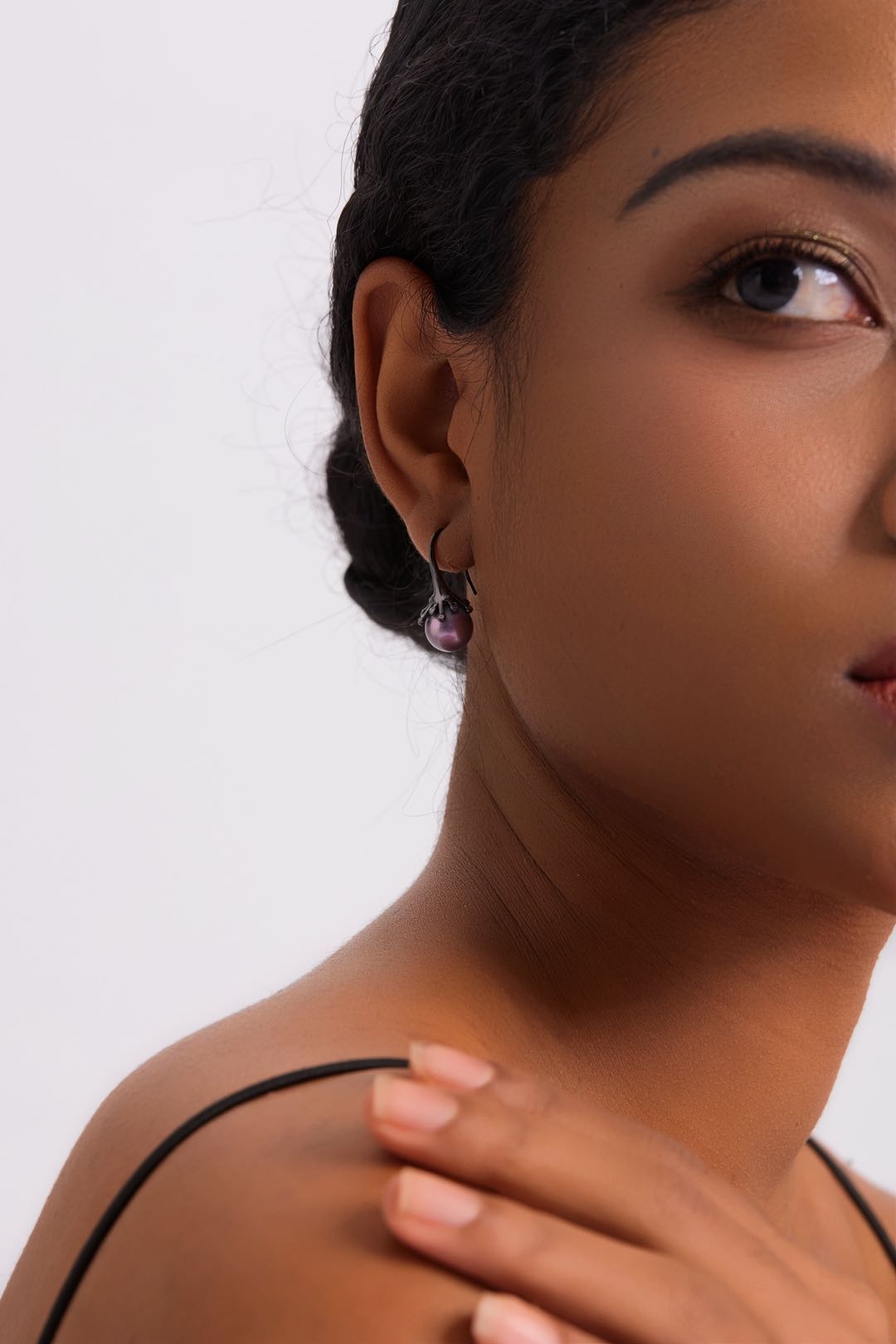 Model wearing Midnight Bloom purple pearl drop earrings with black outfit