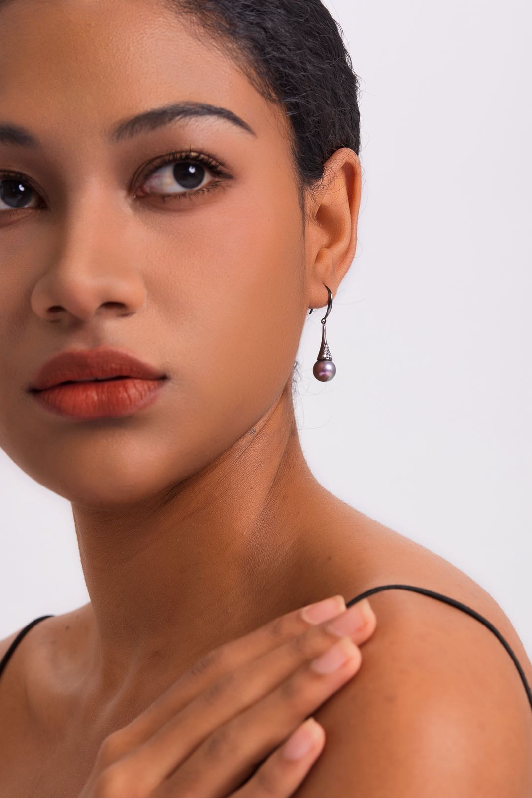 Model wearing Midnight Orchid pearl drop earrings for evening wear