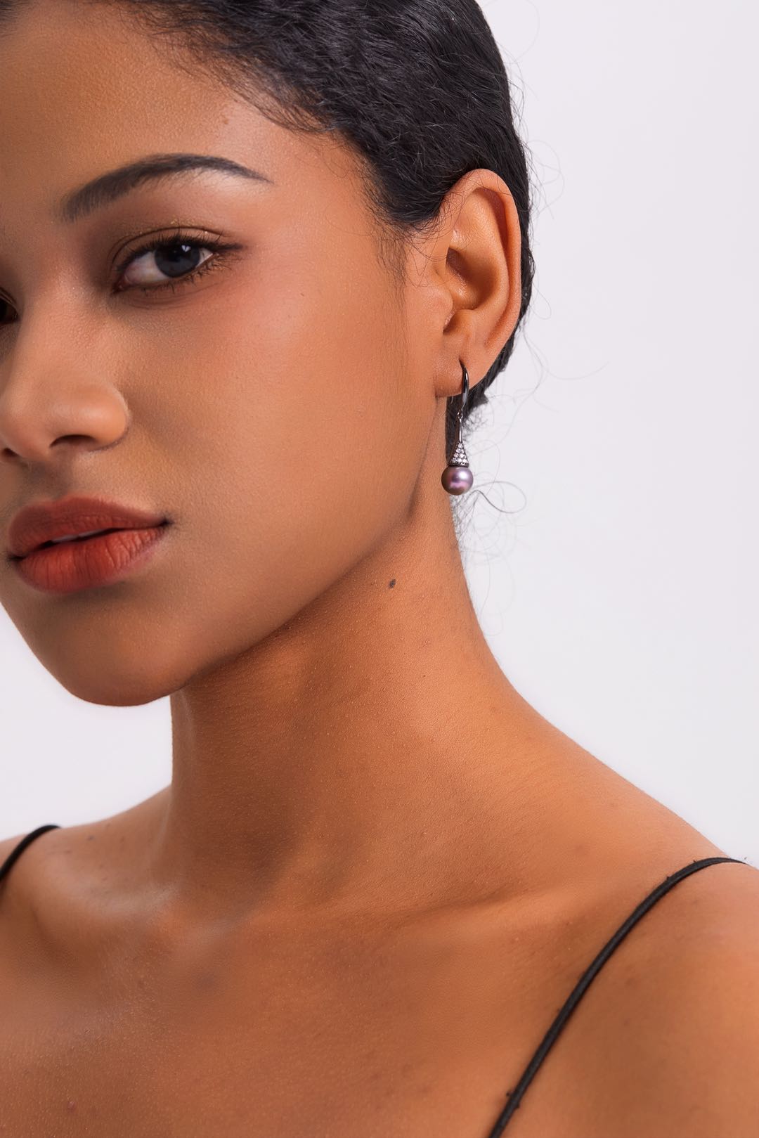 Model wearing Midnight Orchid pearl drop earrings for evening wear