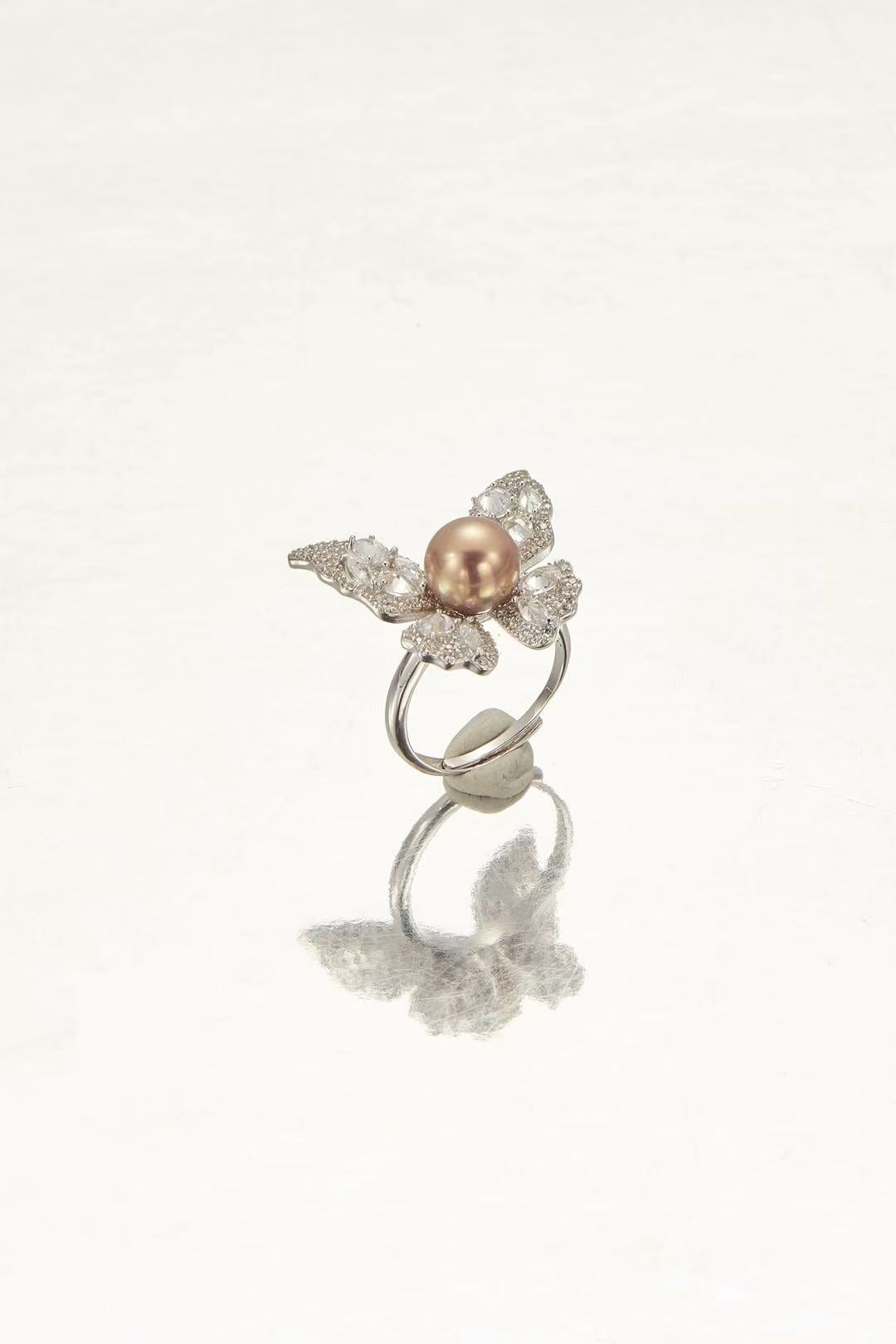 Pink fashion pearl with sparkling CZ butterfly wing design close-up