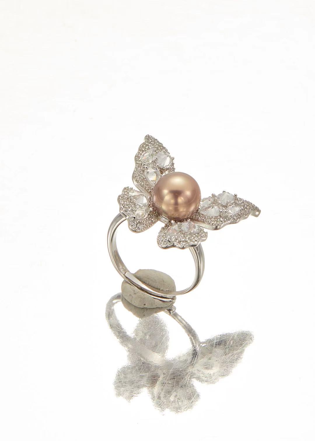 Pink fashion pearl with sparkling CZ butterfly wing design close-up