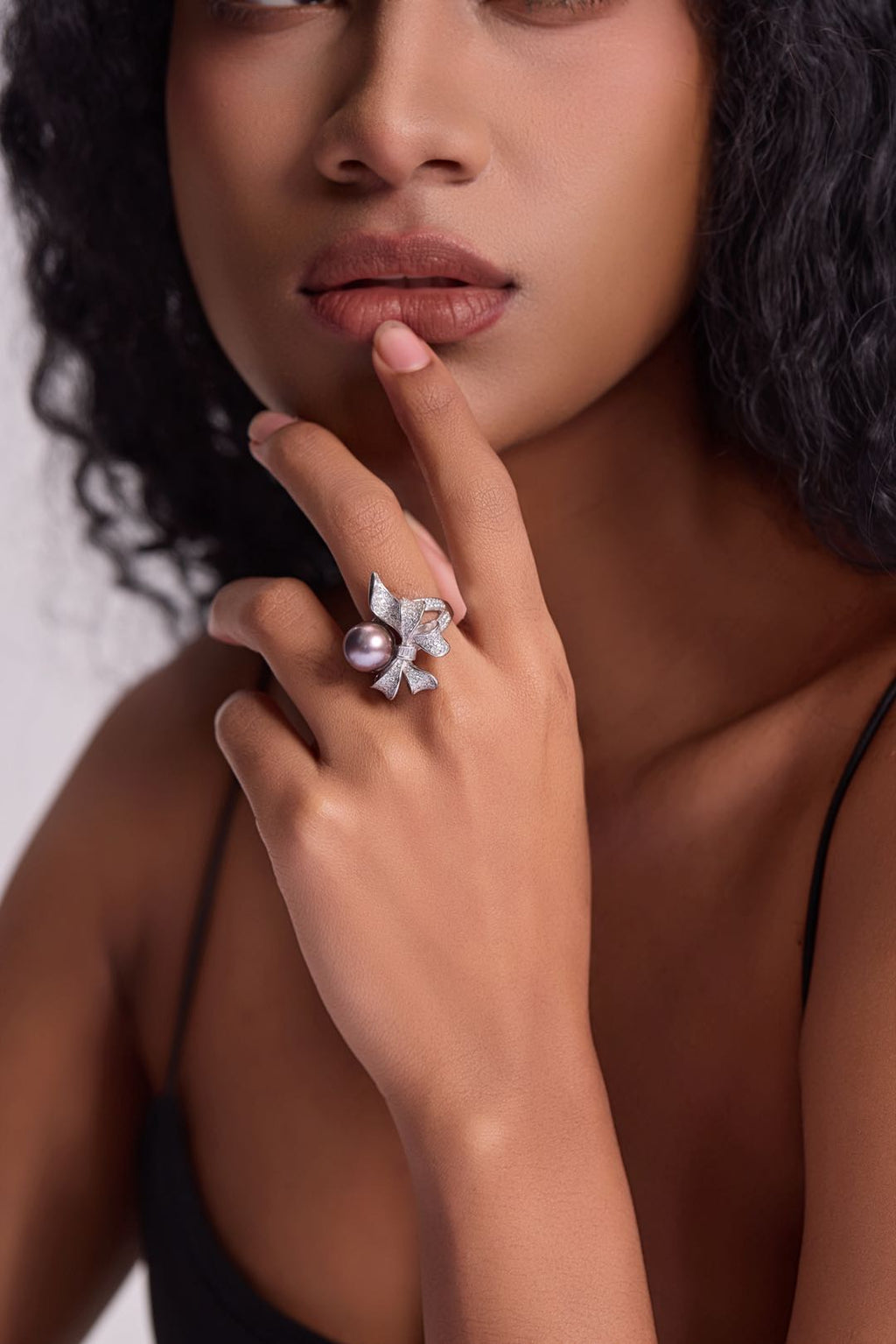 Model wearing Violet Bow pearl ring with little black dress