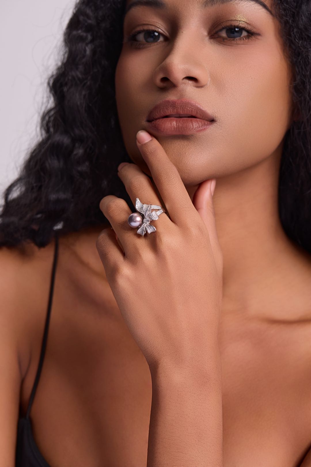 Model wearing Violet Bow pearl ring with little black dress