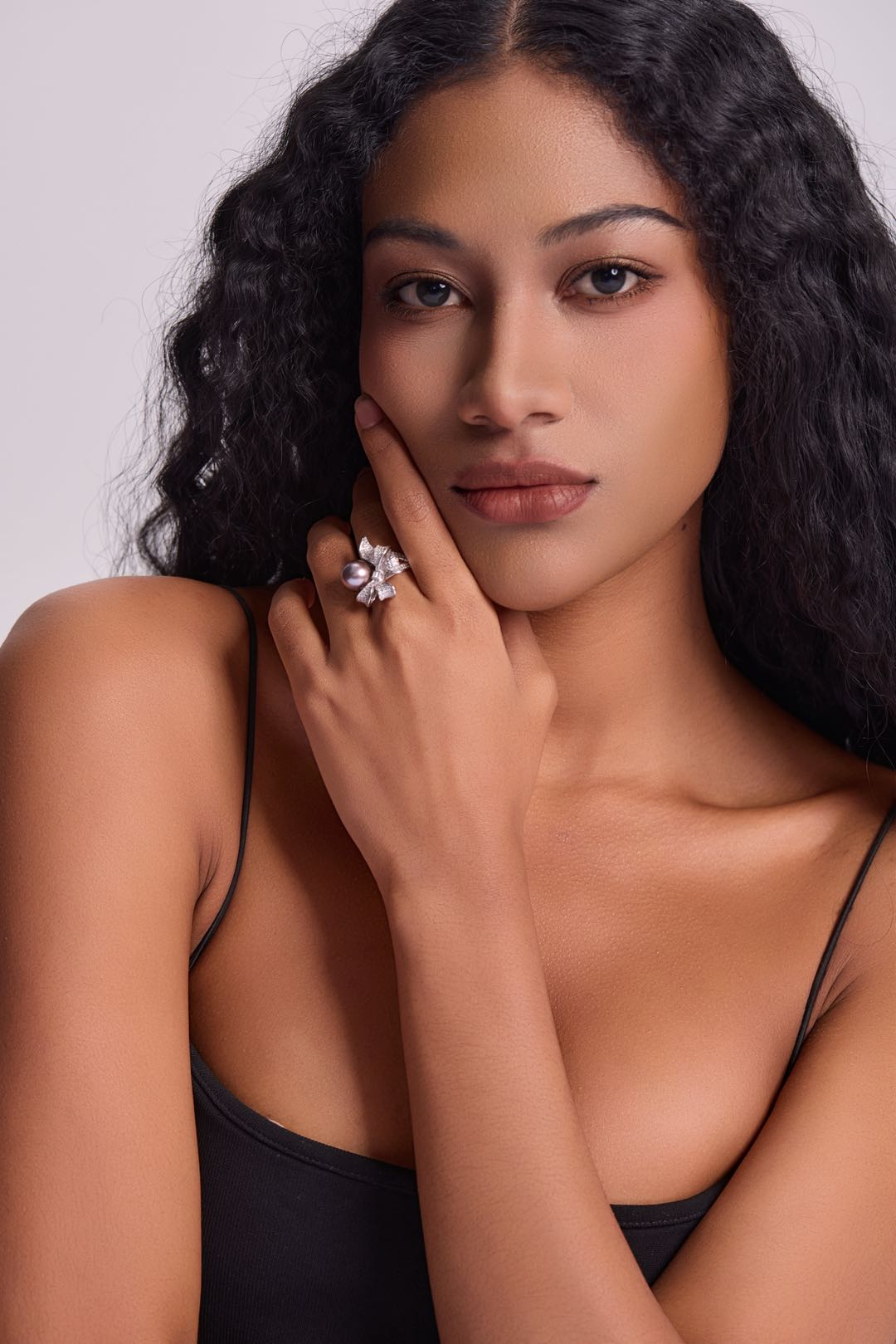 Model wearing Violet Bow pearl ring with little black dress