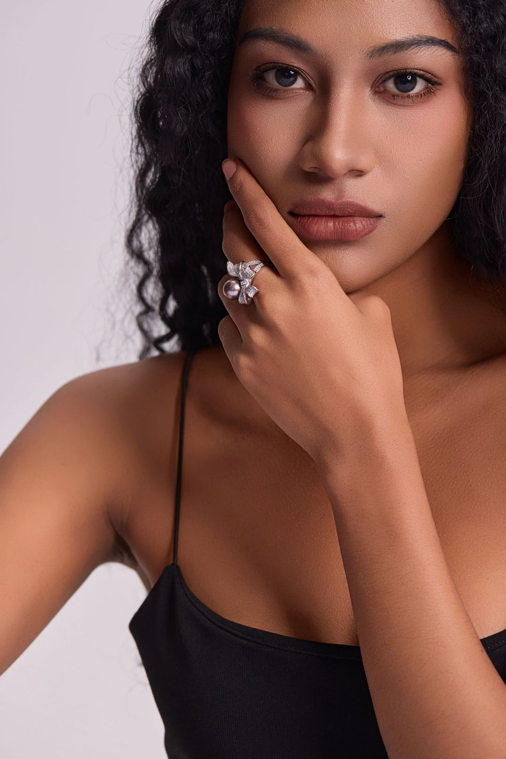 Model wearing Violet Bow pearl ring with little black dress