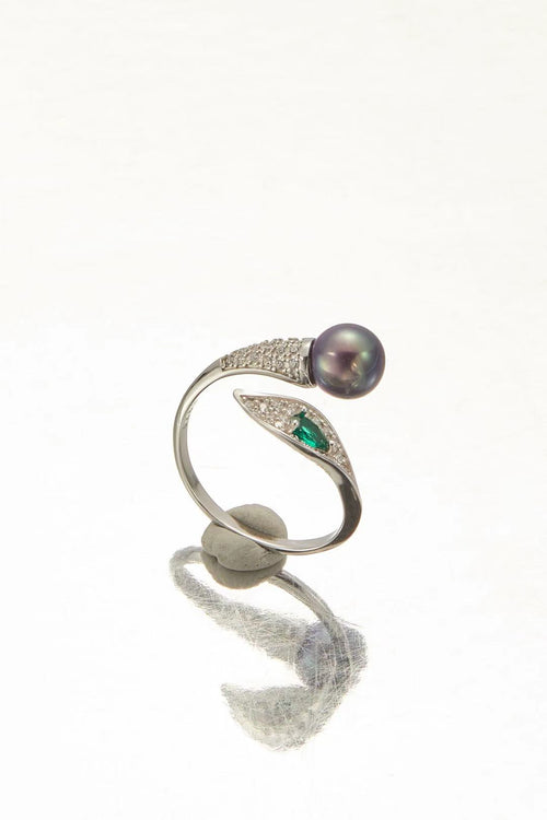 Purple fashion pearl and green teardrop cubic zirconia bypass ring close-up