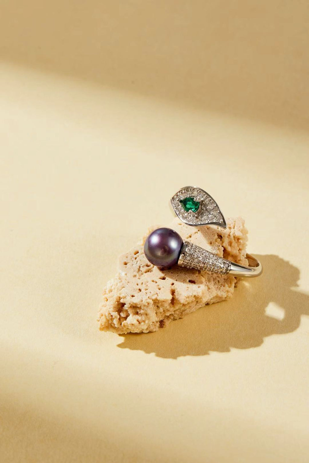 Purple fashion pearl and green teardrop cubic zirconia bypass ring close-up