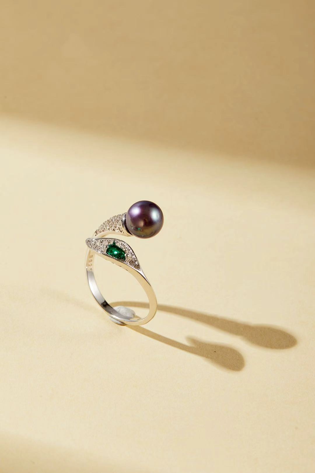 Purple fashion pearl and green teardrop cubic zirconia bypass ring close-up