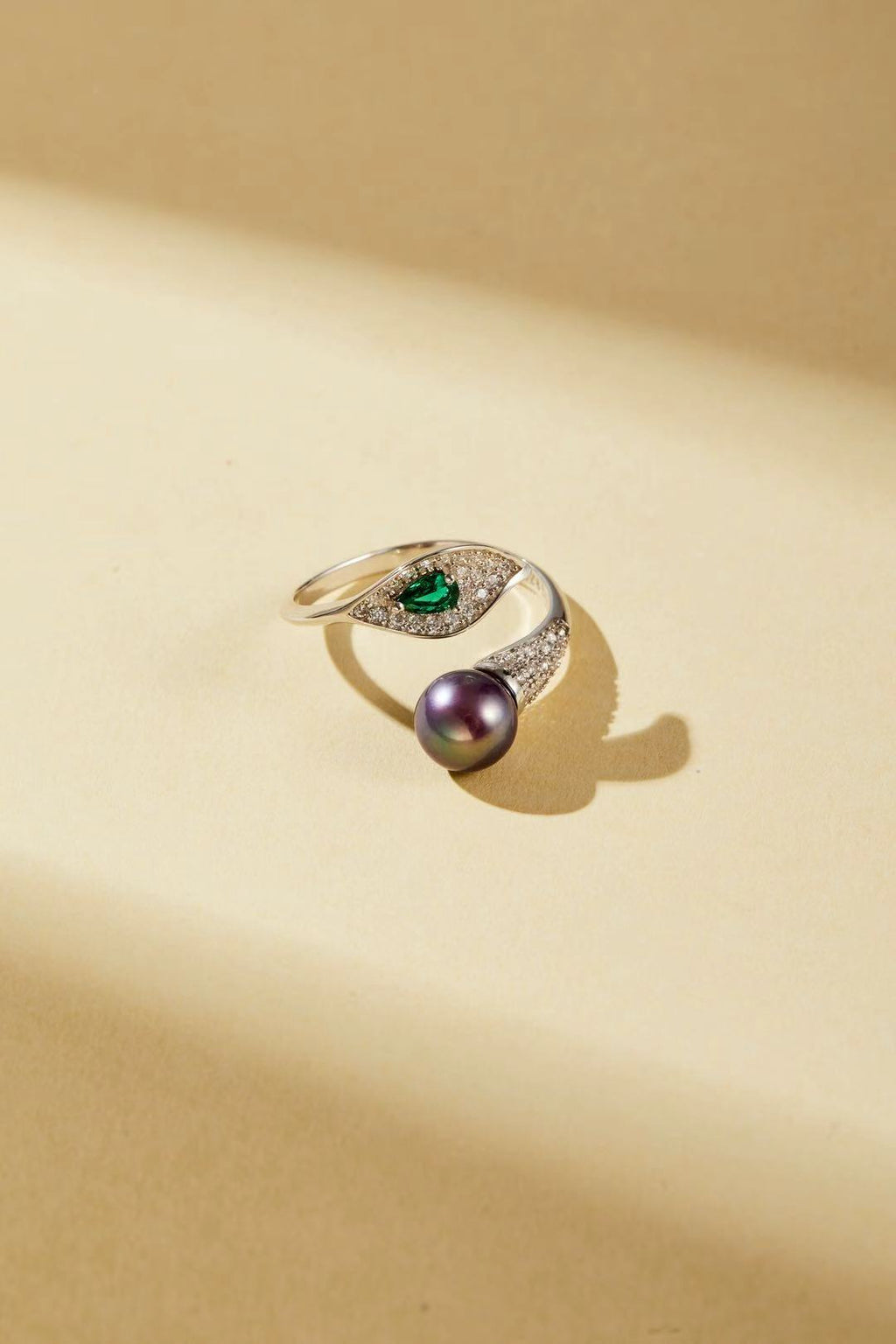 Purple fashion pearl and green teardrop cubic zirconia bypass ring close-up